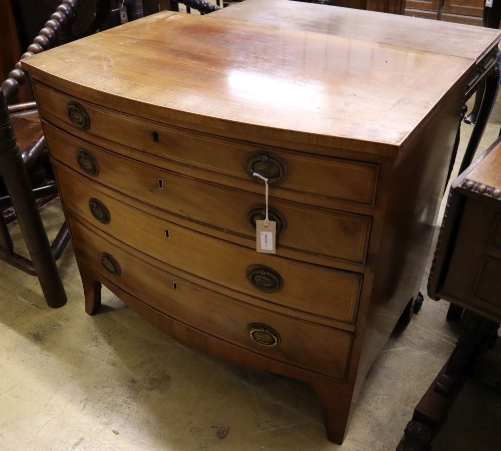 A 19th century banded and inlaid mahogany bow-fronted chest fitted four graduated long drawers, width 86cm depth 56cm height 76cm